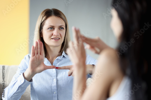 Billede på lærred Two deaf and dumb women talking gestures at home
