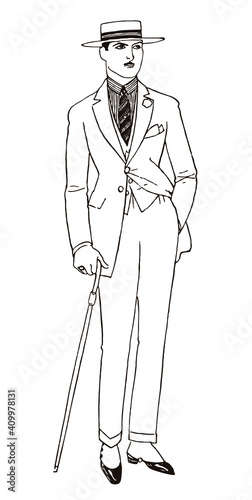 Stylish young man from the 20s with hand in his pocket, wearing suit, flat top wide brim hat and gaiters, holding walking stick 