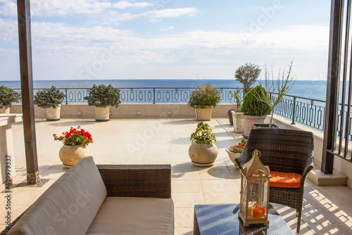 Balcony overlooking the sea. Relaxation area on a large modern terrace in a new building on the first line with panoramic sea views.  Luxury vacation rental. Overseas property on the sea coast.