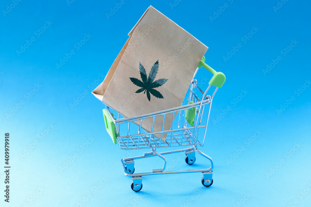 Paper bag with marijuana herb lying in metal shopping basket