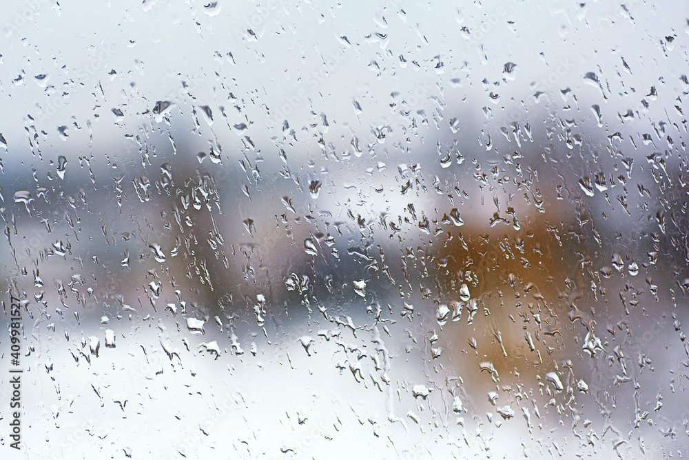 Rainy city background. Raindrops on window glass. Wet home window with raindrops.