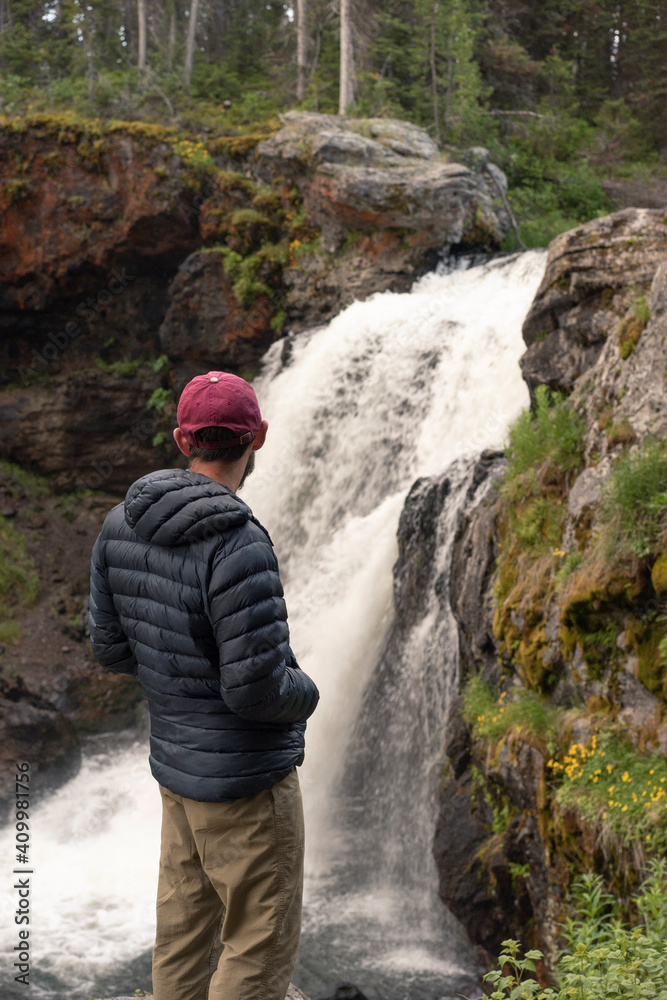 Hiker with Waterfall in Yellowstone National Park