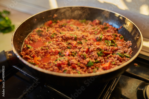 Spaghetti bolognese sauce being fried on a pan