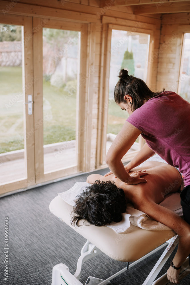 From above of crop unrecognizable female therapist applying lotion and preparing for doing massage for client in spa salon From above of crop unrecognizable female therapist applying lotion and preparing for doing massage for client in spa salon