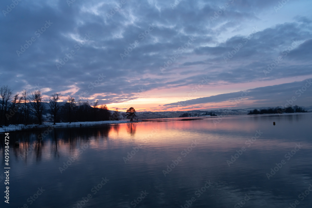 Spectacular winter sunset on the shores of the Upper Zurich Lake (Obersee) near Rapperswil, St. Gallen, Switrzerland