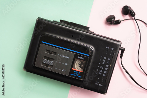 Top view of retro walkman on pink and green background