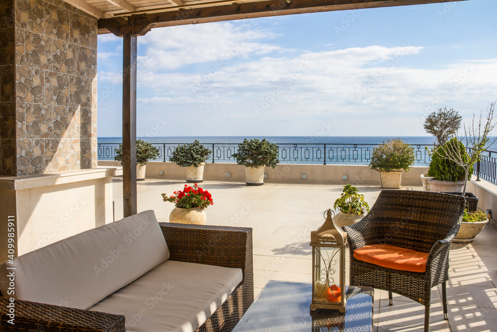 Balcony overlooking the sea. Relaxation area on a large modern terrace in a new building on the first line with panoramic sea views.  Luxury vacation rental. Overseas property on the sea coast.