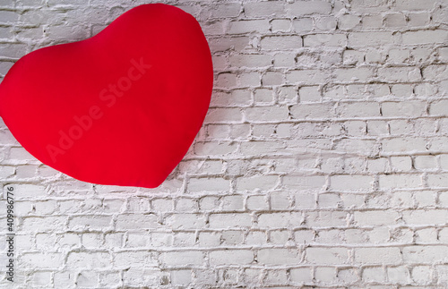 Heart shaped pillow on wall