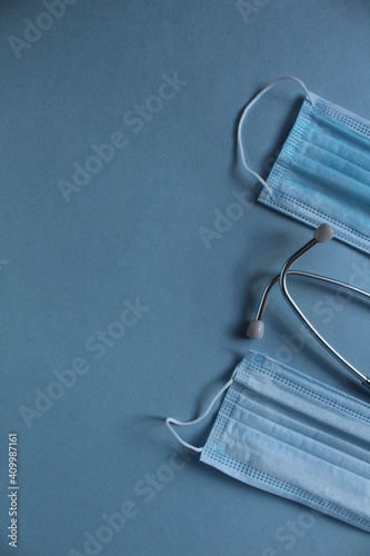 background of the medical mask and stethoscope on a blue blue background with a place for the text of the copyspace