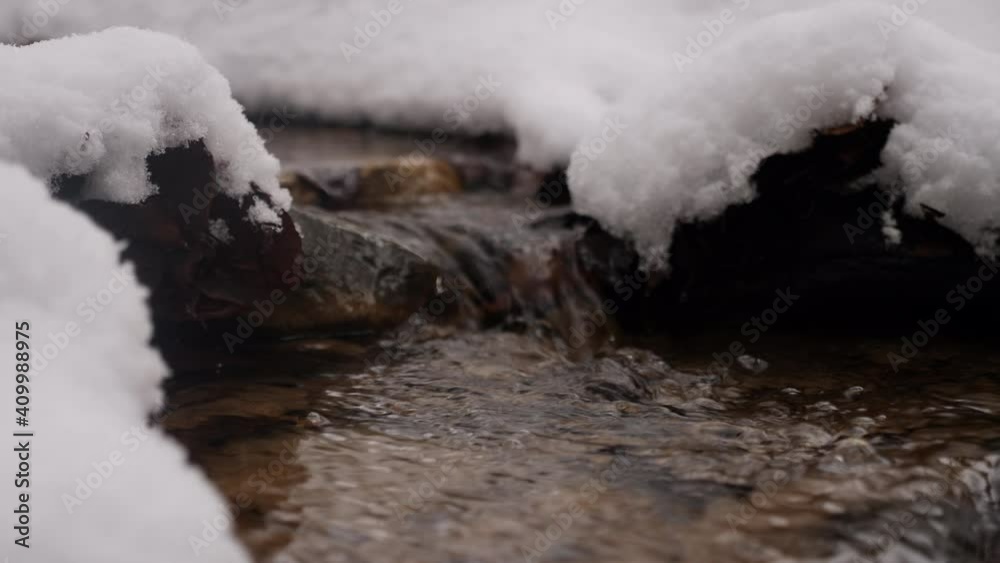 snow on the rocks and on the river