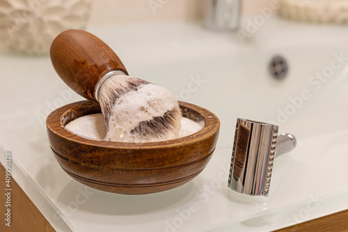 wooden bowl with shaving soap, vegan razor brush and razor photo