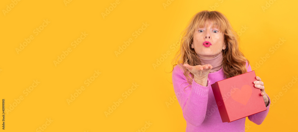 woman with gift box blowing a kiss isolated woman with gift box blowing a kiss isolated