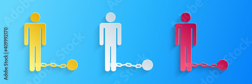 Paper cut Prisoner with ball on chain icon isolated on blue background. Paper art style. Vector.