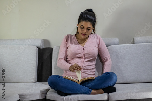 Young woman sitting reading an interesting book