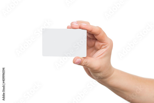 Business card in female hand, closeup isolated on white background. Close up of womans hand holding blank white card