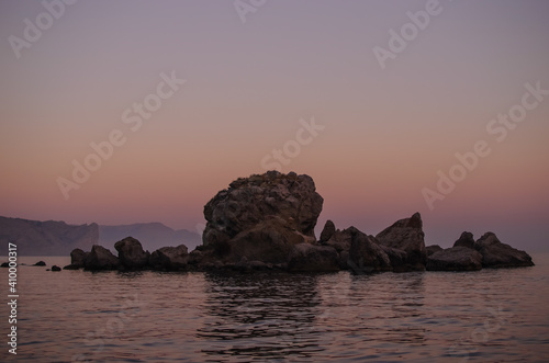 sunset over the sea, rock in the sea, lilac landscape