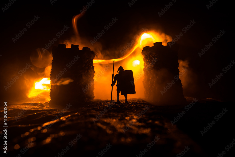 Fototapeta premium Medieval battle scene. Silhouettes of figures as separate objects, fight between warriors at night. Creative artwork decoration. Foggy background.