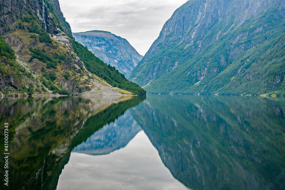 Reflection of mountains on fjord surface at Naeroyfjord near Gudvangen