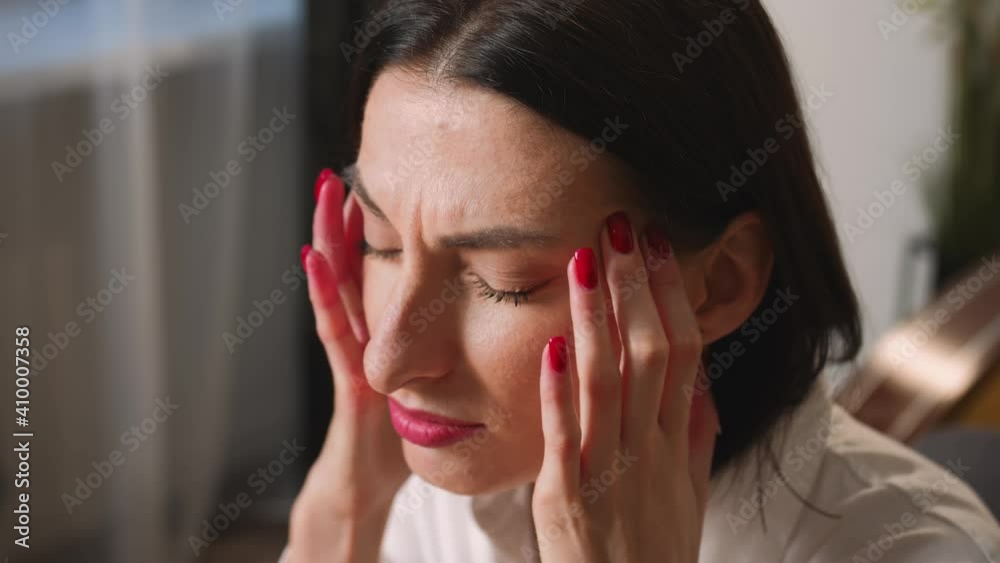 Closeup. Portrait of exhausted frustrated woman massaging nose bridge temples. Stressed unhealthy woman feeling tired suffering from migraine, panic attack, high blood pressure. Closeup. Portrait of exhausted frustrated woman massaging nose bridge temples. Stressed unhealthy woman feeling tired suffering from migraine, panic attack, high blood pressure.