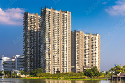 Modern Apartment Buildings on a Sunny Day with a Blue Sky on Chao Phraya River Embankment in Bangkok, Thailand