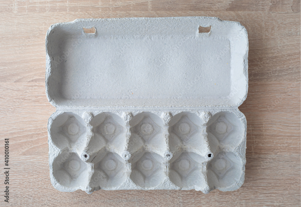 Cardboard egg box. Empty egg carton. Eggs box. Empty box of 10 eggs on a  wooden table Photos | Adobe Stock