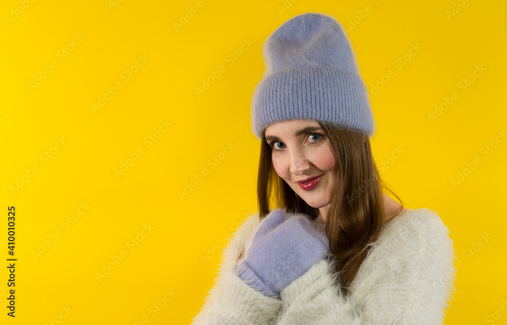 Emotional girl in winter hat, gloves and  expressing happiness