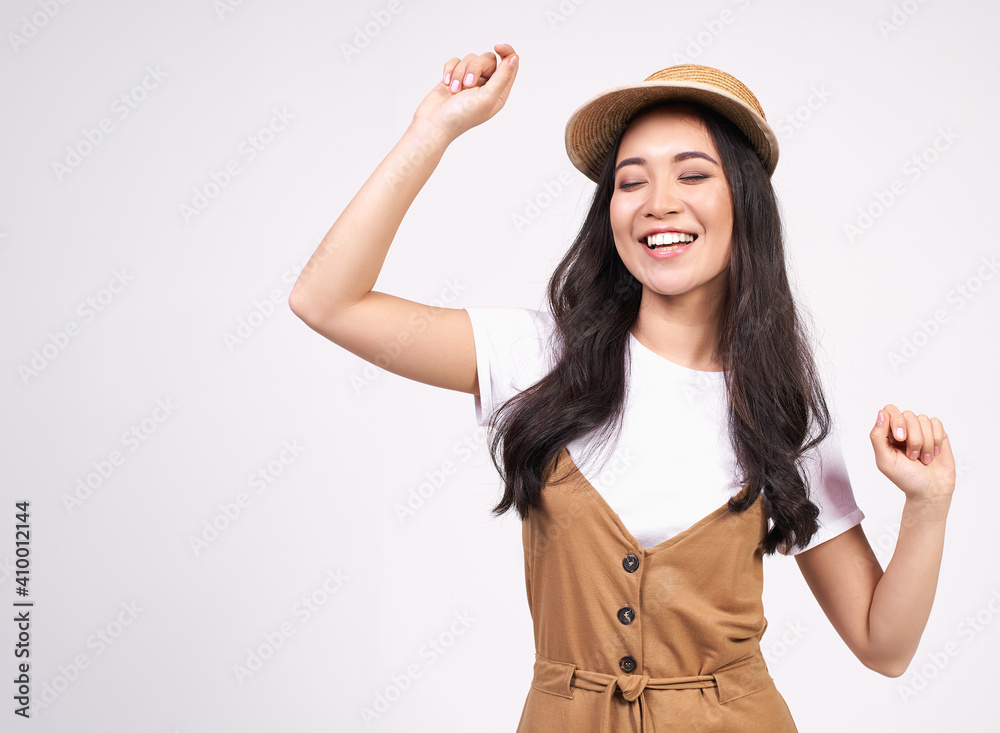 Cheerful Asian girl celebrating a special day, jumps and raise arms with energy. Cheerful Asian girl celebrating a special day, jumps and raise arms with energy.