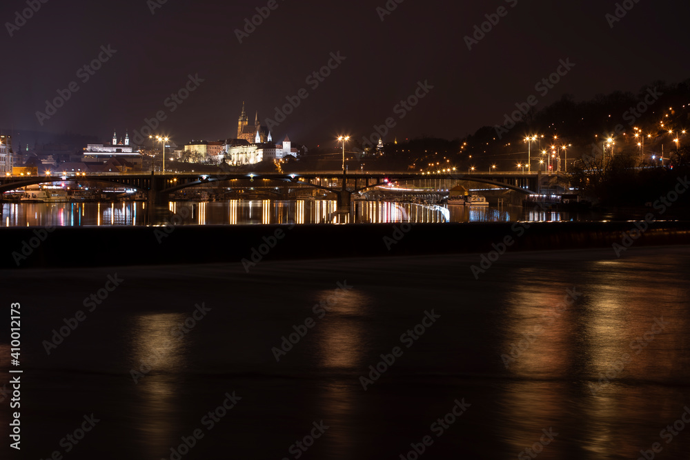 .panoramic view of Prague Castle and St. Vitus Cathedral and the Vltava River and street lights on bridges at night in the center of Prague .panoramic view of Prague Castle and St. Vitus Cathedral and the Vltava River and street lights on bridges at night in the center of Prague