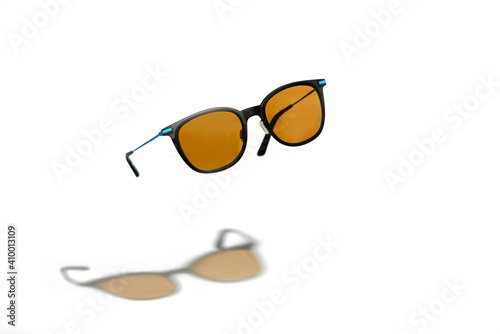Conceptual elegant Sunglasses hovering isolated on white background. Sun glasses summer accessories as design element for promo or advertising banner. High quality photoSunglasses hovering on white