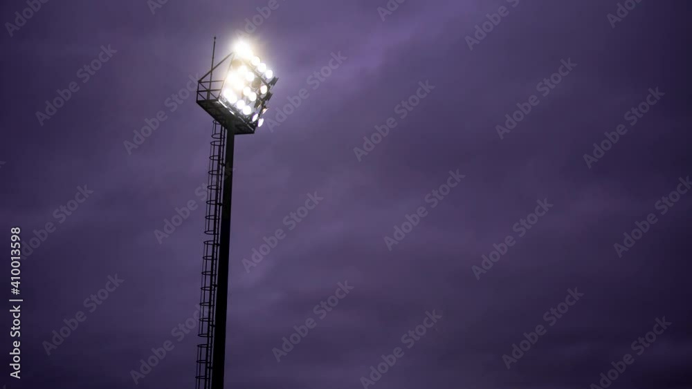 High tower lighting the Stadium of Light in a cloudy twilight sky purple. High quality 4k footage High tower lighting the Stadium of Light in a cloudy twilight sky purple. High quality 4k footage
