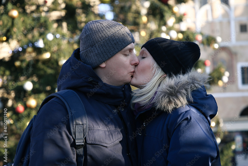 A young couple is kissing in the Old Town Square in Prague Love of a man and a woman. Valentine's Day February 14. A young couple is kissing in the Old Town Square in Prague Love of a man and a woman. Valentine's Day February 14.