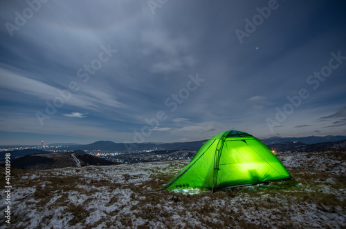 Tent in winter on top of the mountain at night