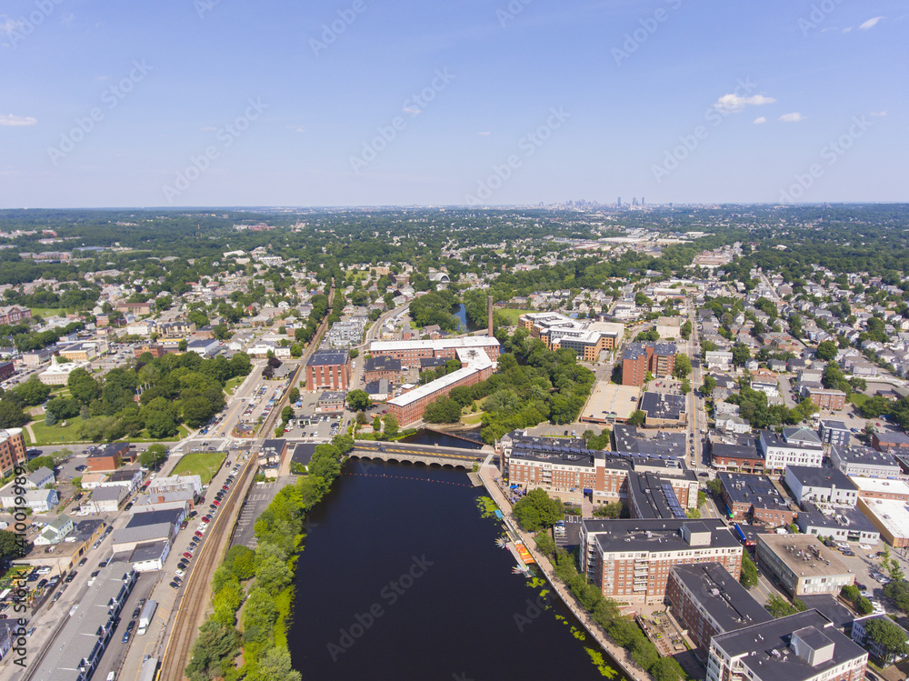 Historic Francis Cabot Lowell Mill building at Charles River and Waltham historic city center aerial view in city of Waltham, Massachusetts MA, USA. 