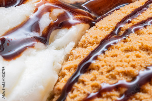 Close-up ice cream with chocolate and cream, with chocolate sauce