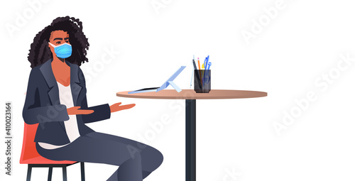 african american businesswoman mask sitting at table and using laptop coronavirus quarantine self isolation concept horizontal portrait vector illustration