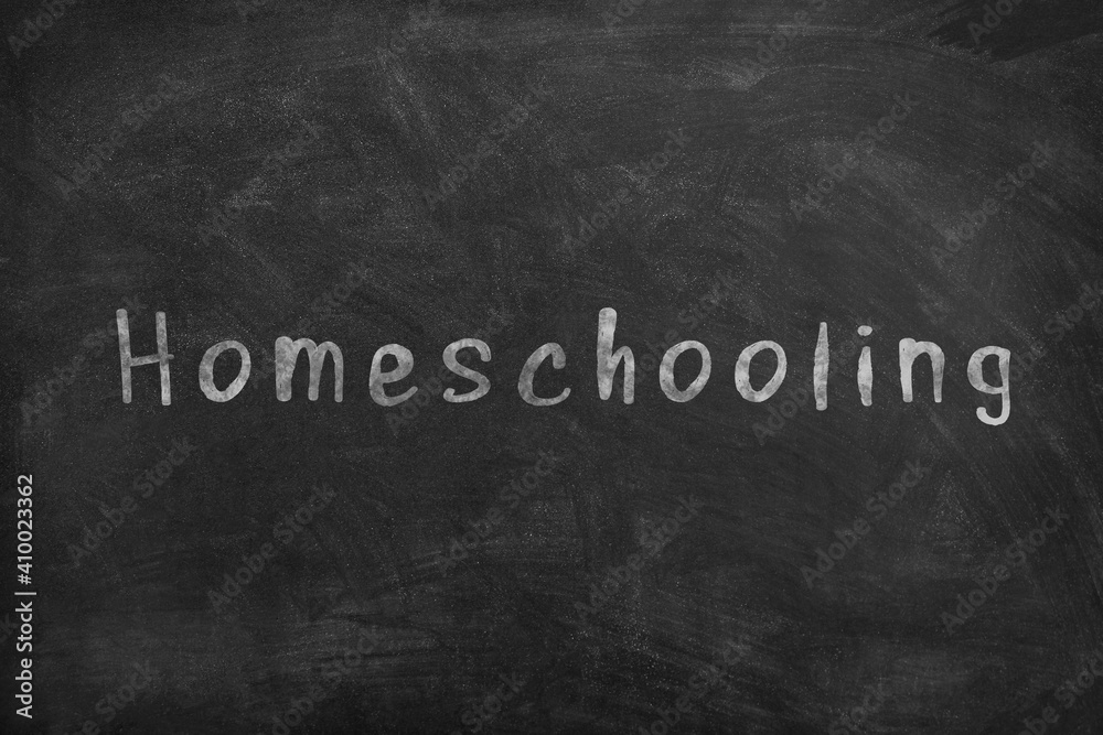 Fototapeta premium Homeschooling. Word Homeschooling written on an old blackboard.