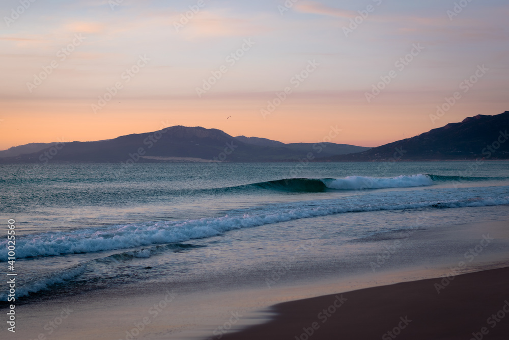 sunset beach with montains background