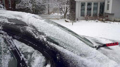 Close Up Scrapping Ice from Rear Windshield