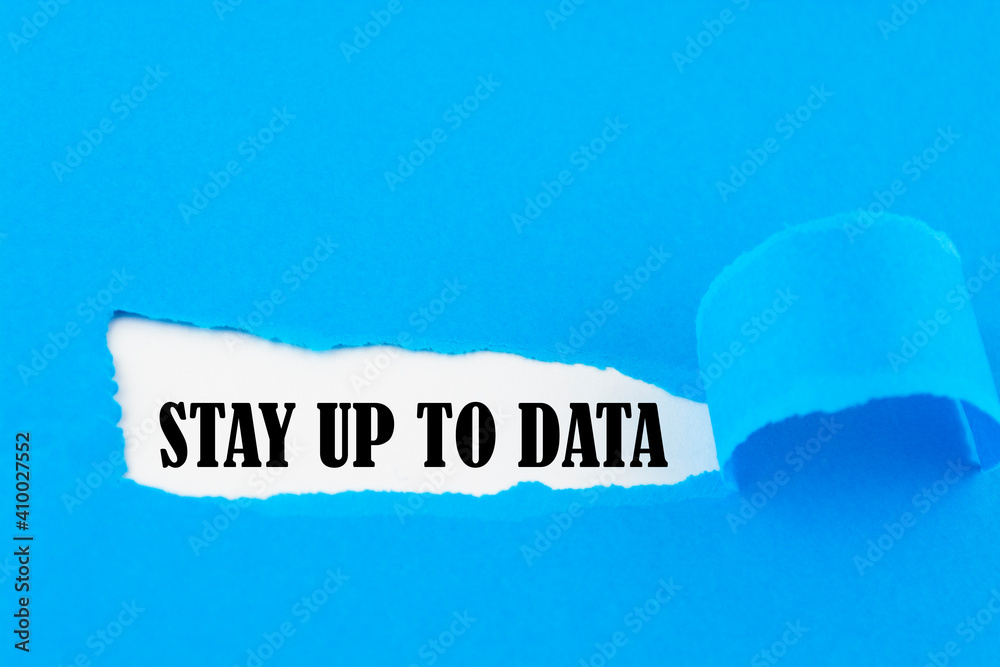STAY UP TO DATA appearing behind torn paper. Business