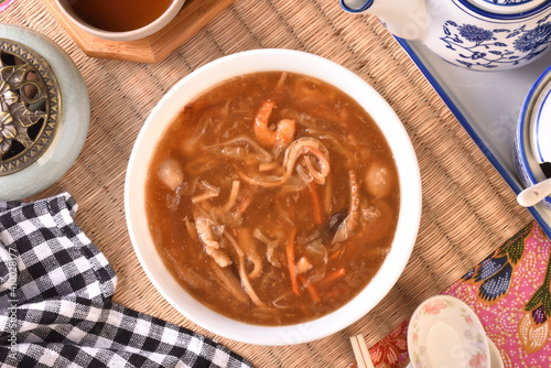 Assorted seafood with scallops soup in white bowl