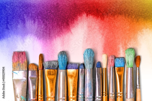 A row of artist paint brushes on desk