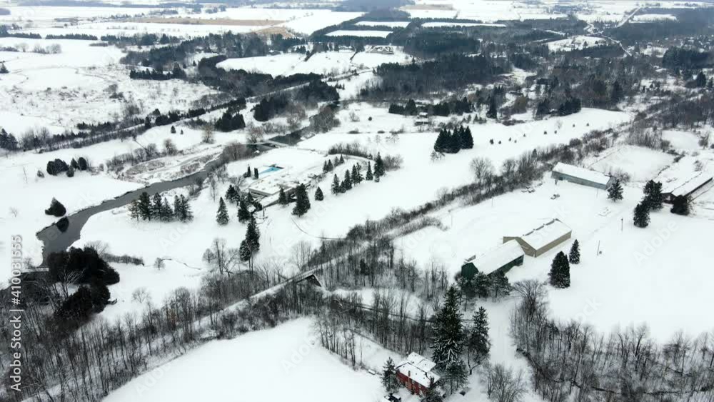 Beautiful winter scenery of countryside residentiel area with houses and trees covered in snow. Aerial revealing shot Beautiful winter scenery of countryside residentiel area with houses and trees covered in snow. Aerial revealing shot