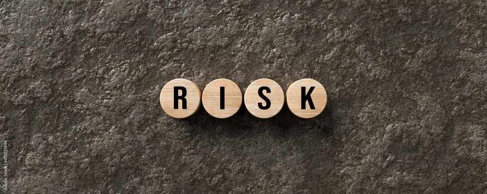 Fototapeta premium message RISK on wet lava stone background