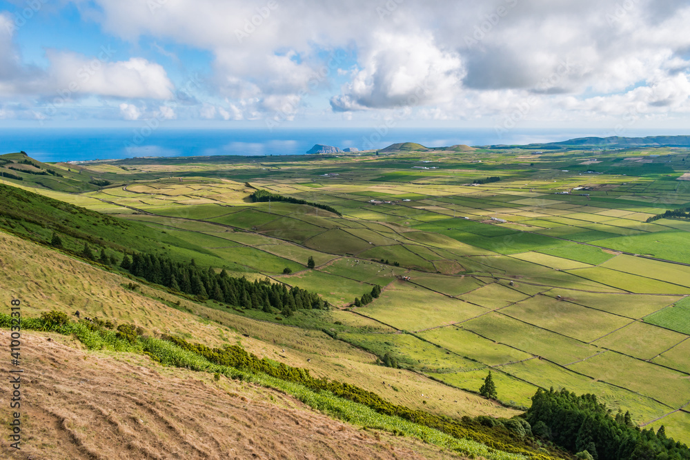 Green fields of ranch pasture on Terceira island in the famous Serra do Cume with Atlantic Ocean on the horizon, Azores PORTUGAL