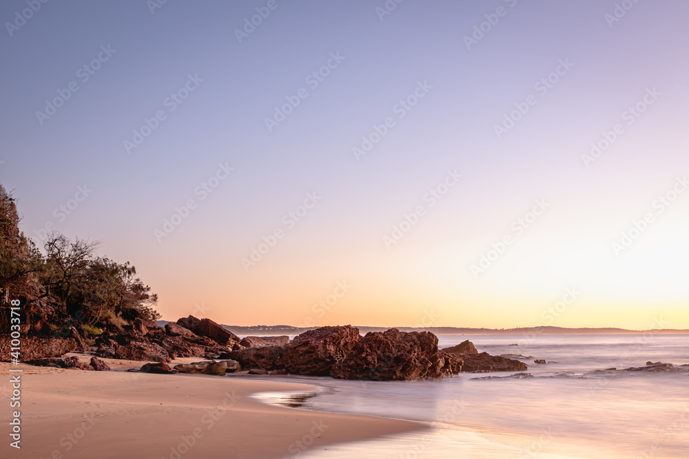 vivid pastel sunrise on rocky the beach in Australia vivid pastel sunrise on rocky the beach in Australia