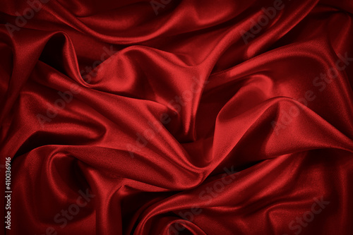 Obraz na płótnie Red silk satin background. Beautiful soft wavy folds on smooth shiny fabric. Anniversary, Christmas, wedding, valentine, event, celebration concept. Red luxury background with copy space for design. w salonie