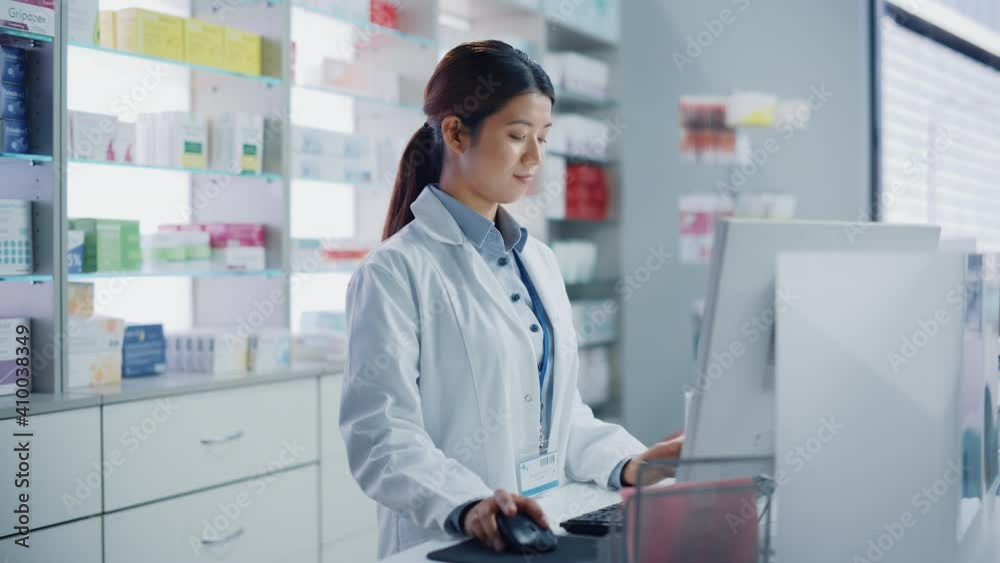 Pharmacy Drugstore: Beautiful Asian Pharmacist Uses Checkout Counter Computer, Does Inventory Checkup, Online Prescription of Medicine Packages, Drugs, Vitamin Boxes, Supplements, Health Care Products