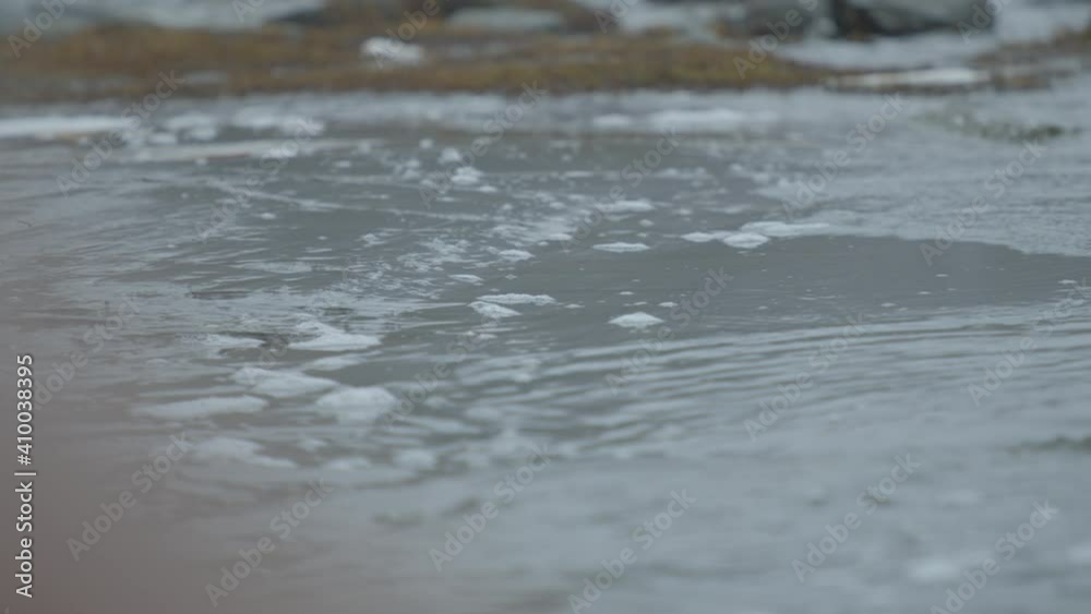 Slow motion water lapping at the edge of a lake Slow motion water lapping at the edge of a lake
