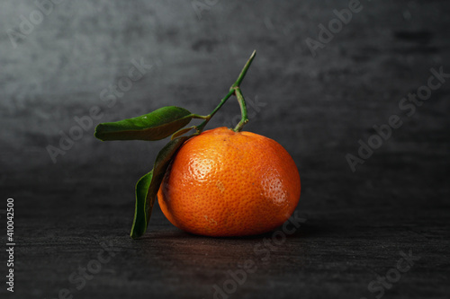 Fresh tangerine on a dark background.