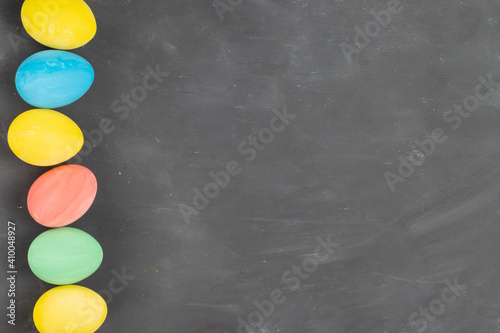 Multicolored painted easter eggs on chalk board kopy space photo